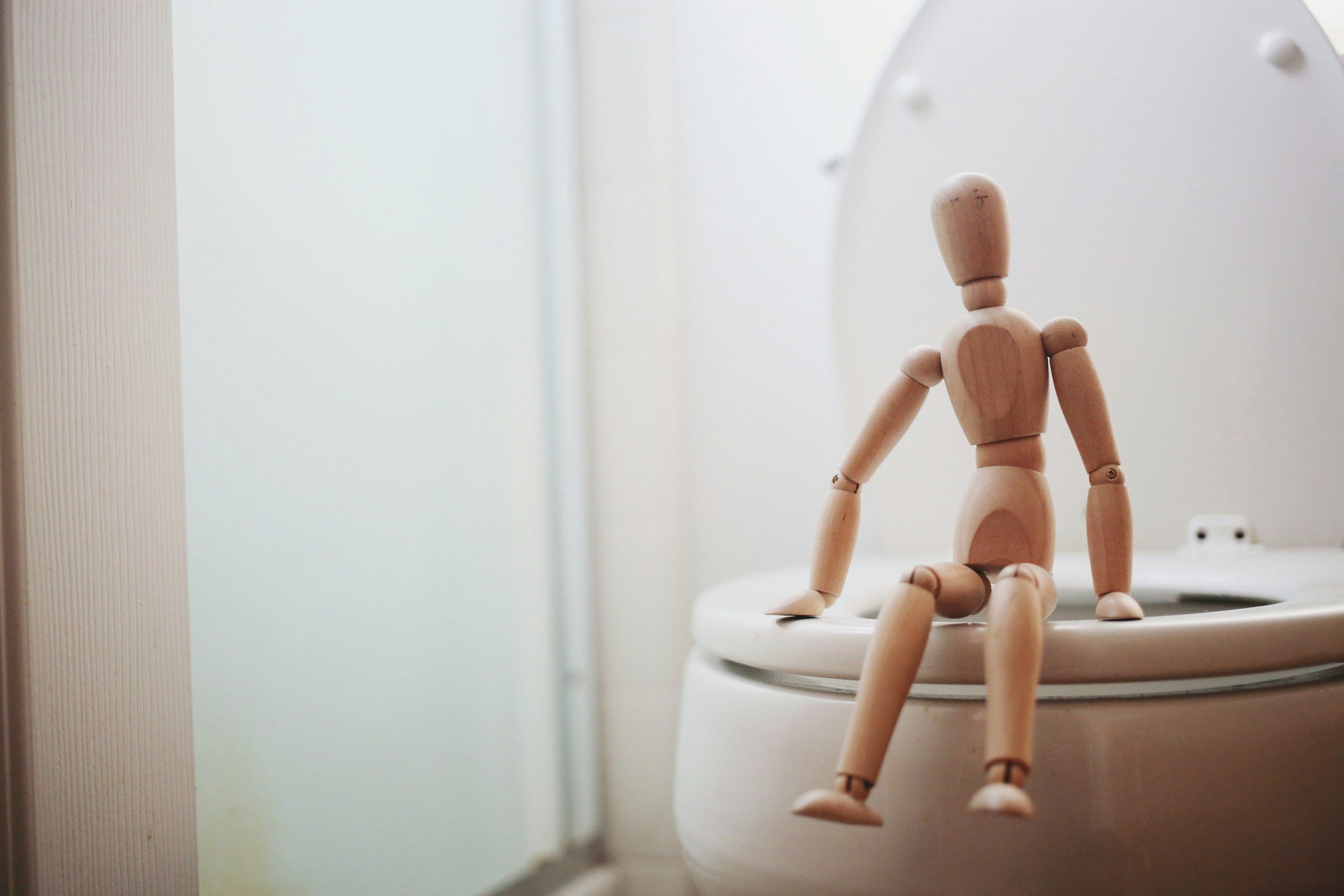 Person looking at a clogged toilet bowl